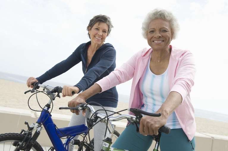 two senior ladies smiling brightly showing good overall health