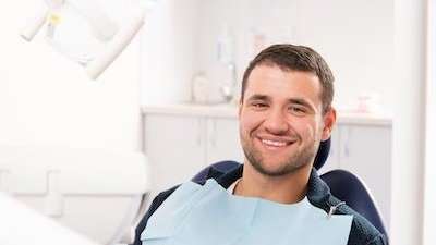 Man smiling after getting dental crowns in Hermitage, PA