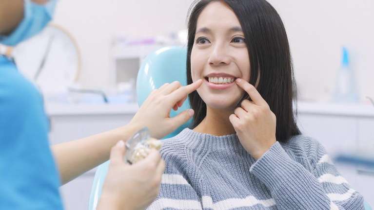Lady undergoing dental cleaning in Hermitage, PA