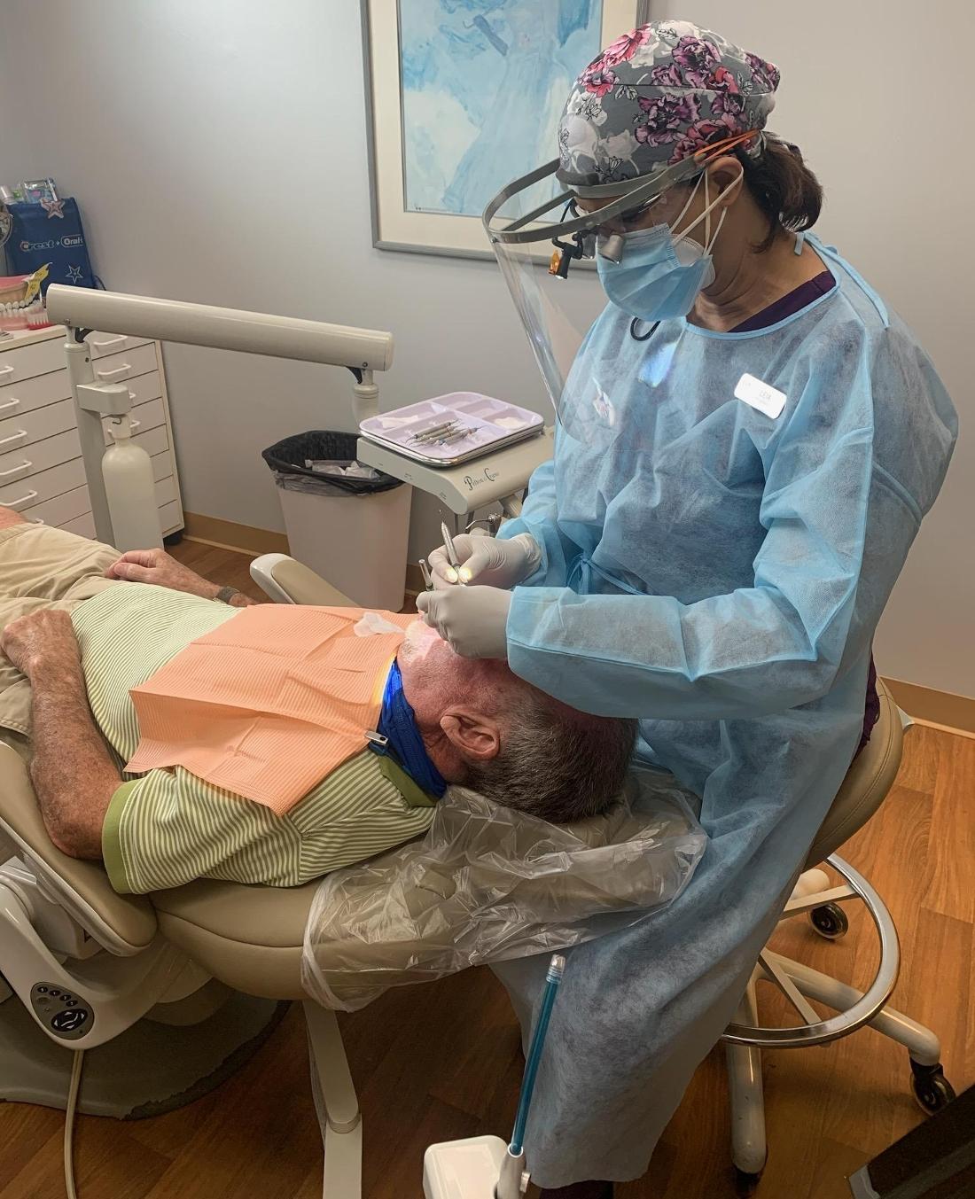 Patient receiving dental cleaning by a hygienist in Hermitage PA