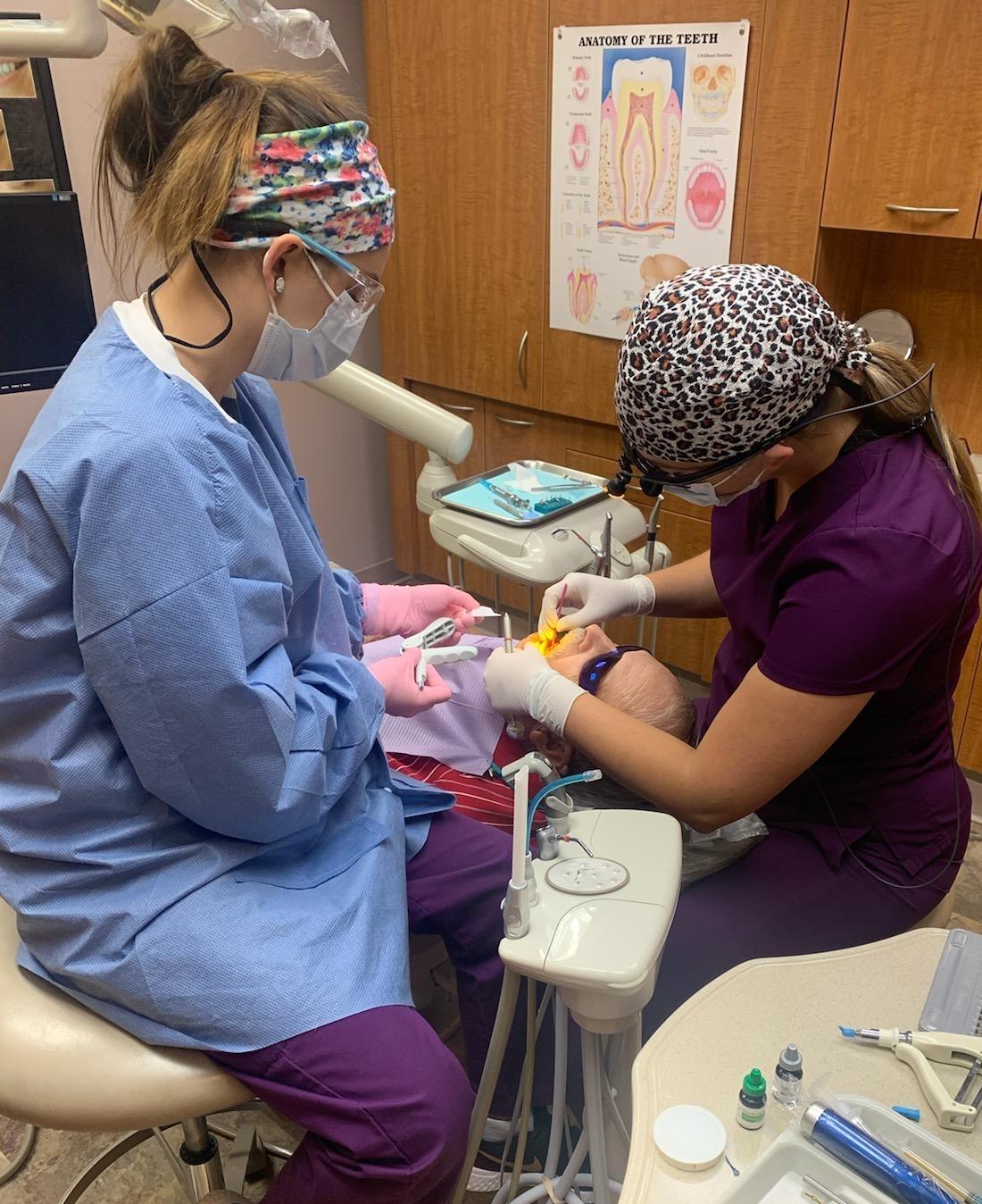 Dental assistants giving patient a tooth colored filling in Hermitage PA