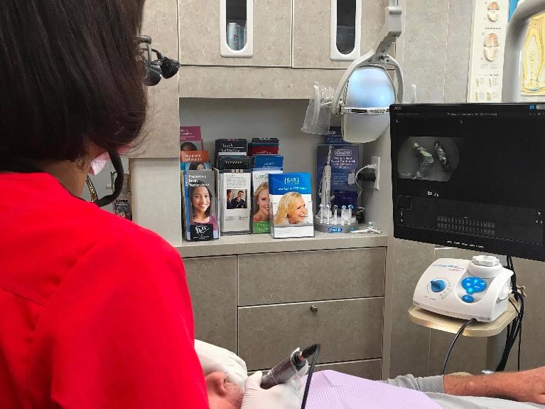 16148 dentist using a Dexis Intraoral Camera during dental exam