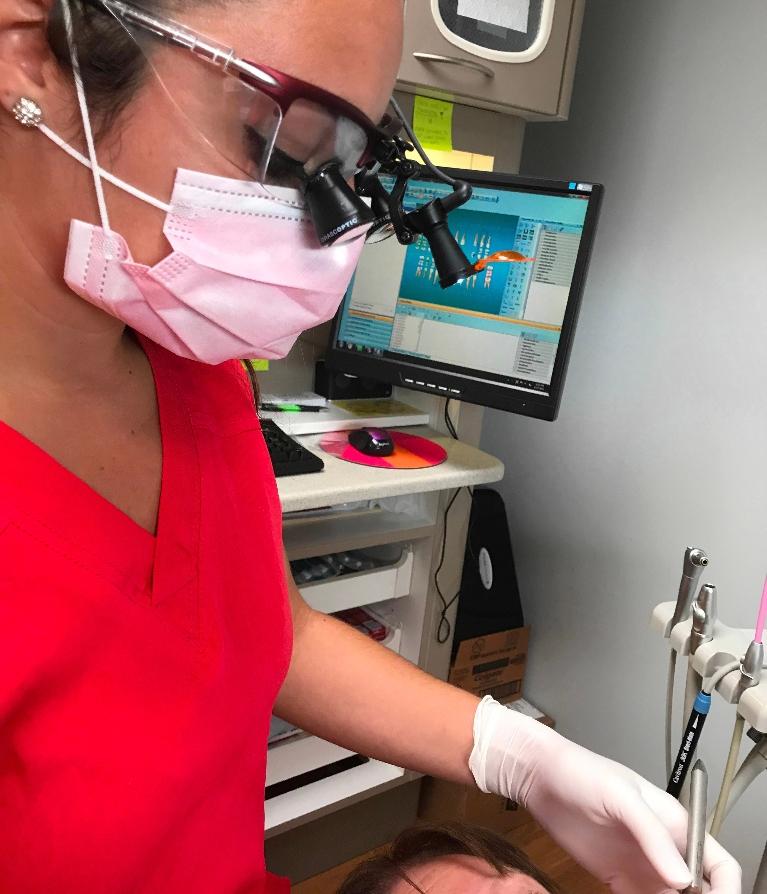 Dentist in Hermitage PA wearing Orascoptic Telescopic Loupes during dental exam